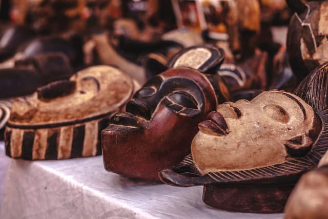 Carved wooden African masks on display.