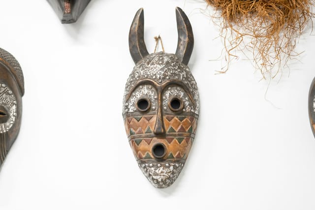 Traditional African masks hanging on a wall